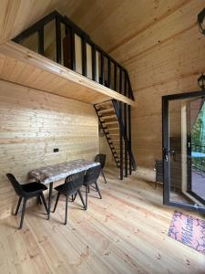 a room with a table and chairs and a staircase at Glola A-Frame Cottages in Glola