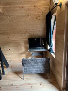 a room with a desk and a laptop in a cabin at Glola A-Frame Cottages in Glola
