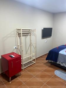 a bedroom with a bed and a tv in a room at Flat Yellowtuna in Fernando de Noronha