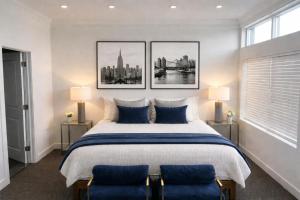 a bedroom with a large bed with three pictures on the wall at Daniella's Suites in Peabody +79 photos