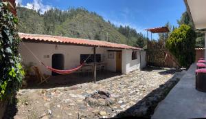 a house with a hammock in front of it at Casa I Love Huaraz in Huaraz