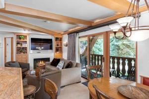 a living room with a couch and a fireplace at Christiania Condominiums- CoralTree Residence Collection in Vail