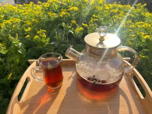 a tea pot and a cup sitting on a table at Altamem apartment in Um Qeis
