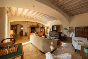 a living room with a couch and a chess board at Hotel Les Messugues in Saint Paul de Vence