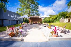 a restaurant with tables and chairs and umbrellas at Hotel Vista Alegre in Barranquitas