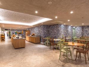 a restaurant with tables and chairs in a room at B&B HOTEL Rio Copacabana Forte in Rio de Janeiro