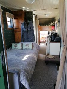a bedroom with a bed in an rv at Theddlethorpe Horsebox Glamping in Theddlethorpe Saint Helen