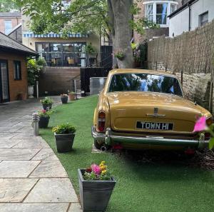 an old car parked on the grass in a yard at Durham Central Suites in Gilesgate