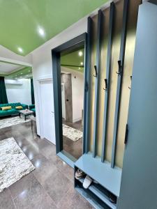 a bathroom with a mirror and a blue cabinet at Cataleya III in Sarajevo +20 photos
