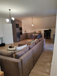 a living room with a couch and a table at U prolazu in Đakovo