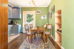 a kitchen with a dining room table and chairs at La Quiete del Mattino in Torre Pellice