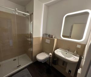 a bathroom with a toilet and a sink and a shower at Deck 8 in Timmendorfer Strand
