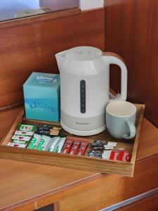 a coffee maker sitting on top of a wooden shelf at The Limes Hotel in Market Rasen