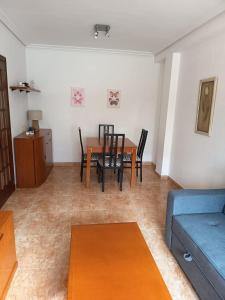 a living room with a table and chairs and a couch at Casa en vigo in Vigo +9 photos