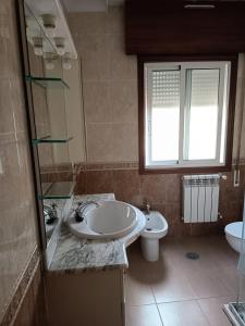 a bathroom with a sink and a toilet at Casa en vigo in Vigo