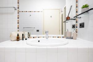a white bathroom with a sink and a shower at Vittoria Residence Spanish Steps in Rome +12 photos