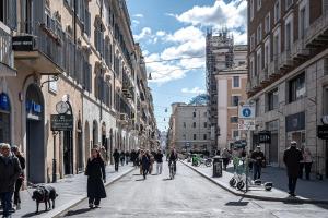a group of people walking down a city street at Vittoria Residence Spanish Steps in Rome