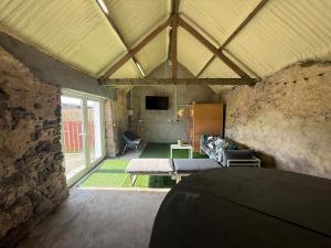 a living room with a couch and a table at Dessie's in Magherasaul