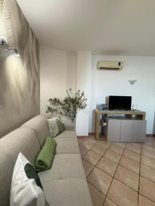 a living room with a couch and a tv at Villa Degli Ulivi in Furore