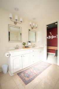 a bathroom with two sinks and a mirror at Eden at Blue Lane in Olathe