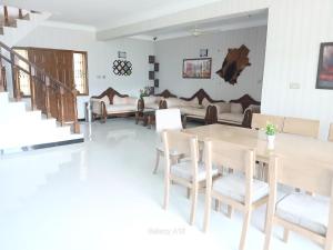 a living room with a table and chairs and a couch at SKYmount in Murree