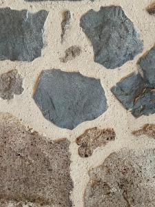 a group of rocks in the sand on a beach at Abri Tiny House in Murat
