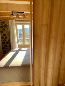 a bedroom with a bed and a window at Abri Tiny House in Murat