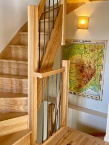 a staircase in a home with a wooden stair case at Abri Tiny House in Murat +23 photos