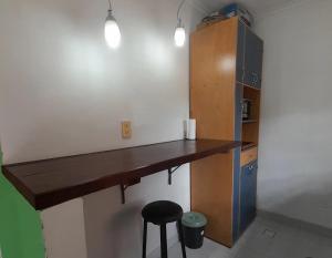 a kitchen with a wooden counter and a stool at Temporario Elisa in Santa Fe