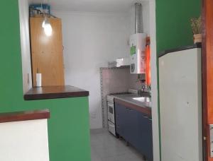 a small kitchen with a sink and a refrigerator at Temporario Elisa in Santa Fe +1 photo