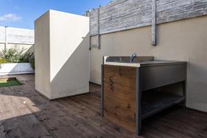 a bathroom with a sink on a patio at Relax Stay - Camere e Appartamenti con Giardino in Quartu Sant'Elena