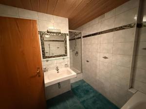 a bathroom with a sink and a mirror at Haus Sauberbach in Jerzens +28 photos