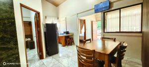 a kitchen and dining room with a wooden table and chairs at Casa el Corral #2 in Aguacate