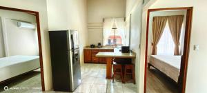 a kitchen with a refrigerator and a table in it at Casa el Corral #2 in Aguacate +3 photos