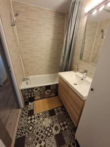 a bathroom with a sink and a shower and a tub at Entre lac et montagne in Les Angles +14 photos