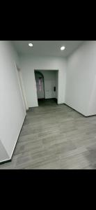 an empty room with white walls and a wooden floor at Dzor house in Yerevan