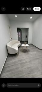 a living room with a white couch and a table at Dzor house in Yerevan