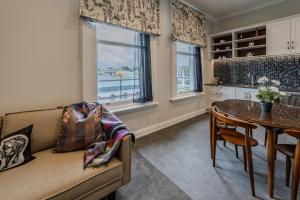 a living room with a couch and a table at The Empire Hotel in Timaru +102 photos