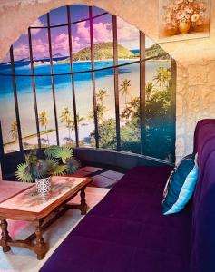 a room with a table and a view of the ocean at Nature, évasion, jacuzzi, grande piscine et cinéma in Houdancourt