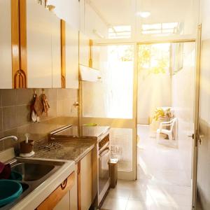 a kitchen with a sink and a stove at Casa Aloe by My Home Apulia in Torre Lapillo +17 photos