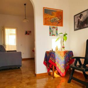 a living room with a table and a chair at Casa Aloe by My Home Apulia in Torre Lapillo