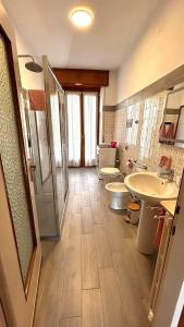 a bathroom with two sinks and two toilets at Lago Maggiore Green House in Leggiuno +39 photos
