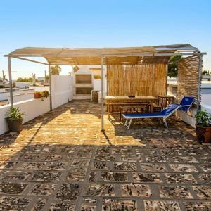 a patio with a table and a piano at Casa Aloe by My Home Apulia in Torre Lapillo
