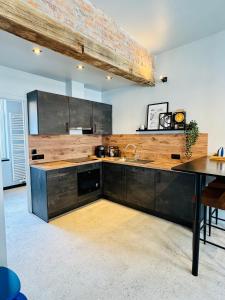 a kitchen with wooden cabinets and a table in it at DinLoft in Dinant +7 photos