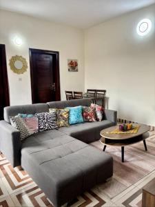 a living room with a couch and a coffee table at Synacassi 2 in Abidjan