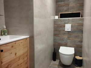 a bathroom with a white toilet and a sink at O Clarée in Val-des-Prés +17 photos