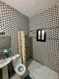 a bathroom with a toilet and a sink at Synacassi 2 in Abidjan