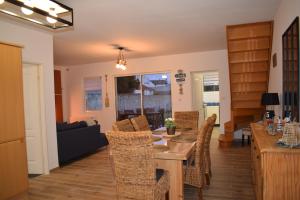 a dining room and living room with a table and chairs at brise marine in Le Crotoy +8 photos