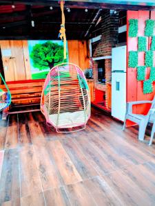 a rattan swing is hanging in a room at CABAÑA tipo habitación con PALAPA y Asador Planta Alta en Zacatlán in Zacatlán