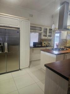 a kitchen with a refrigerator and a counter top at Ludinz Self Catering Accommodation Bellville in Avondale